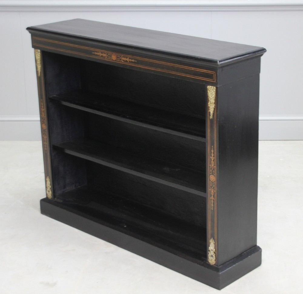 A Victorian ebonized open bookcase View V
