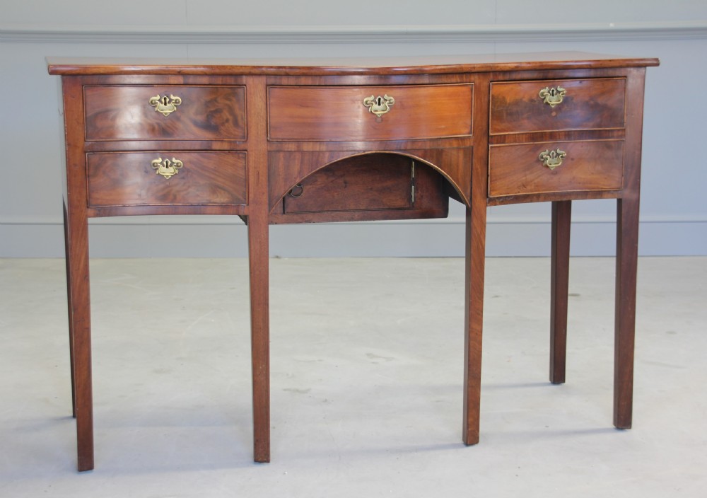 A REGENCY MAHOGANY SERPENTINE SIDEBOARD View III