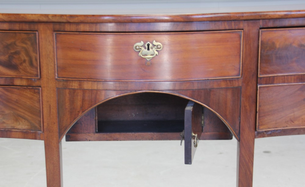 A REGENCY MAHOGANY SERPENTINE SIDEBOARD View VII