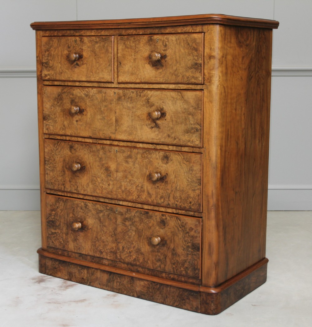 A Victorian burr walnut chest of drawers. View II