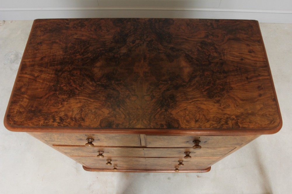 A Victorian burr walnut chest of drawers. View VIII