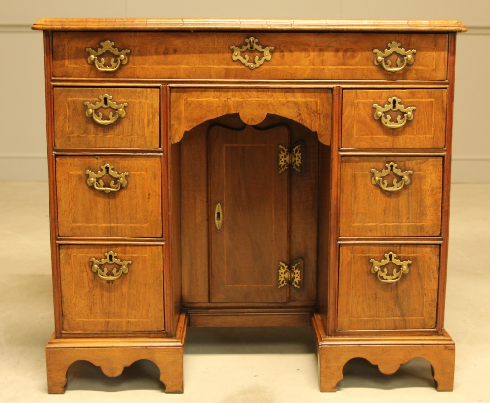 An early 18th century walnut kneehole desk. View II