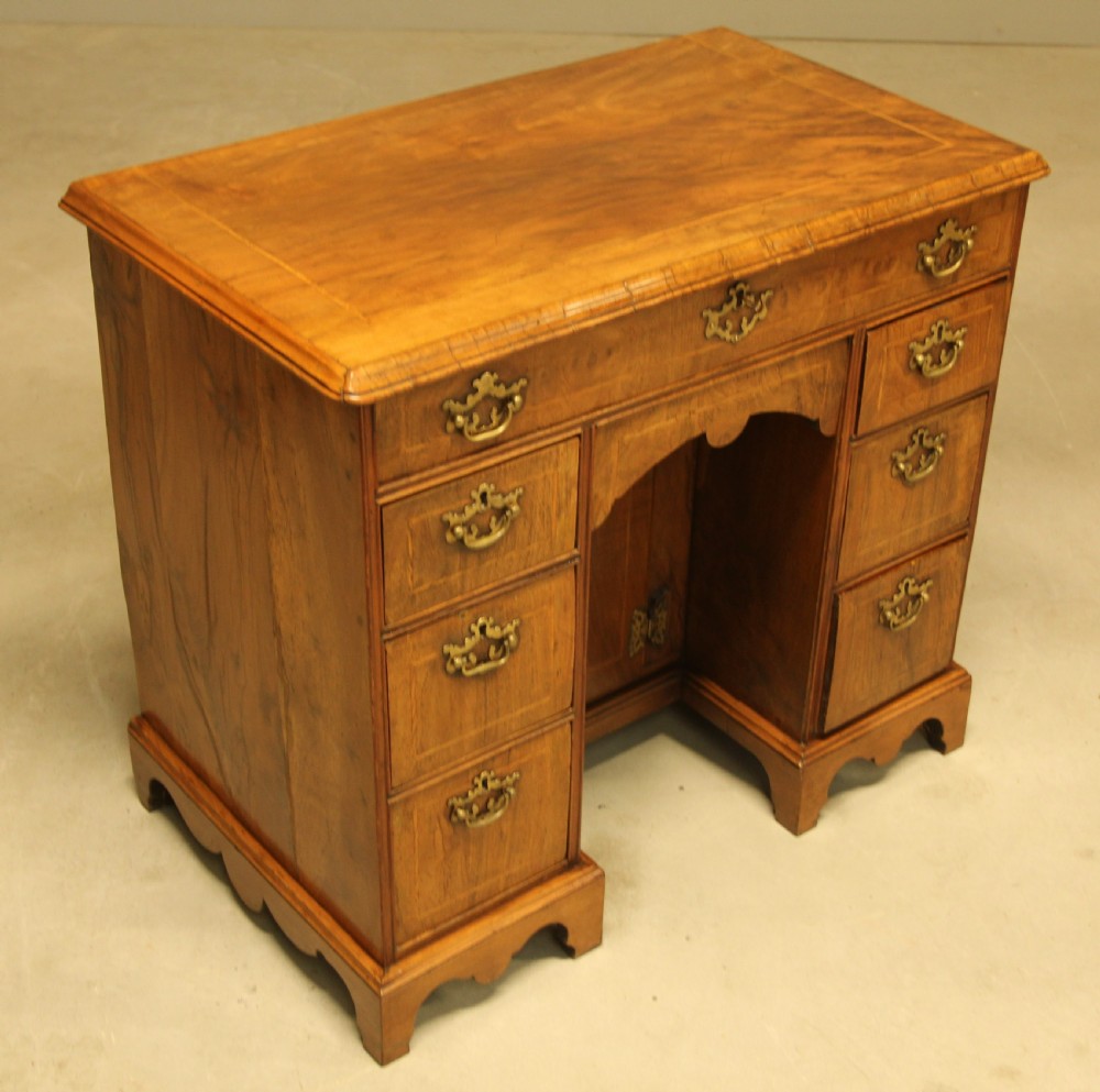 An early 18th century walnut kneehole desk. View V