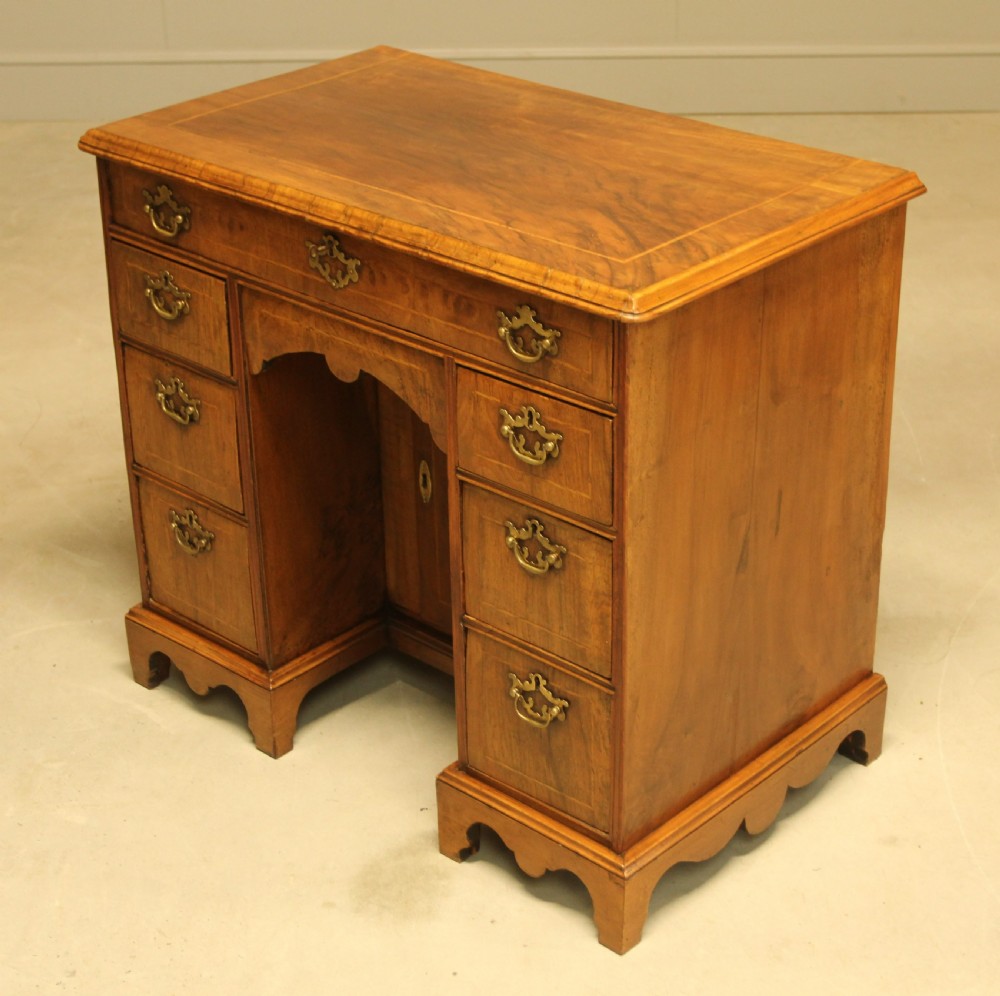 An early 18th century walnut kneehole desk. View VI