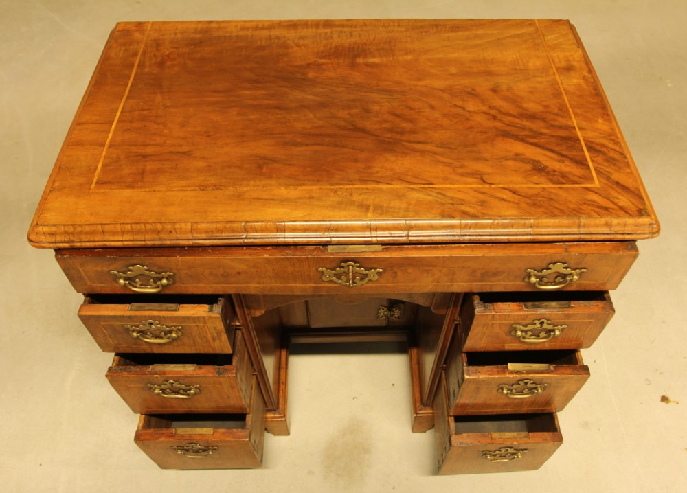 An early 18th century walnut kneehole desk. View VII