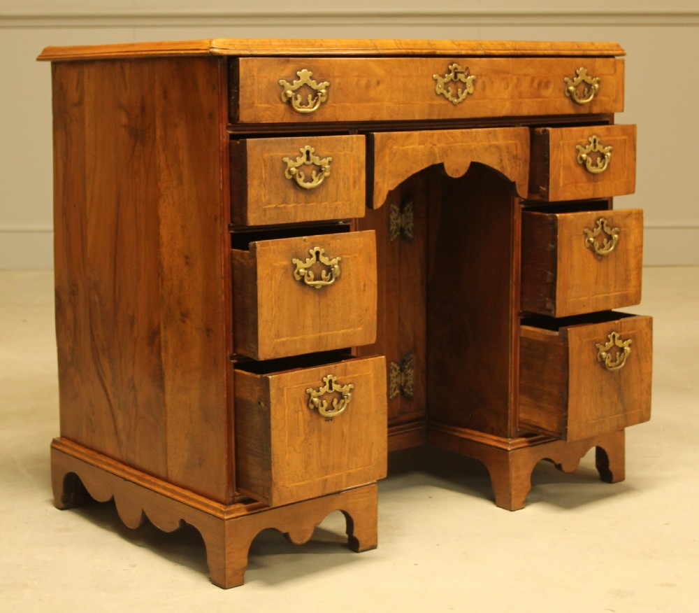 An early 18th century walnut kneehole desk. View VIII