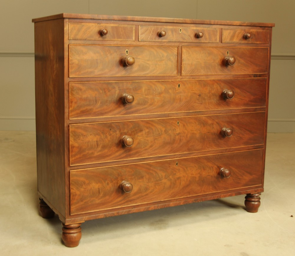 A 19th century flame mahogany chest of drawers. View IV