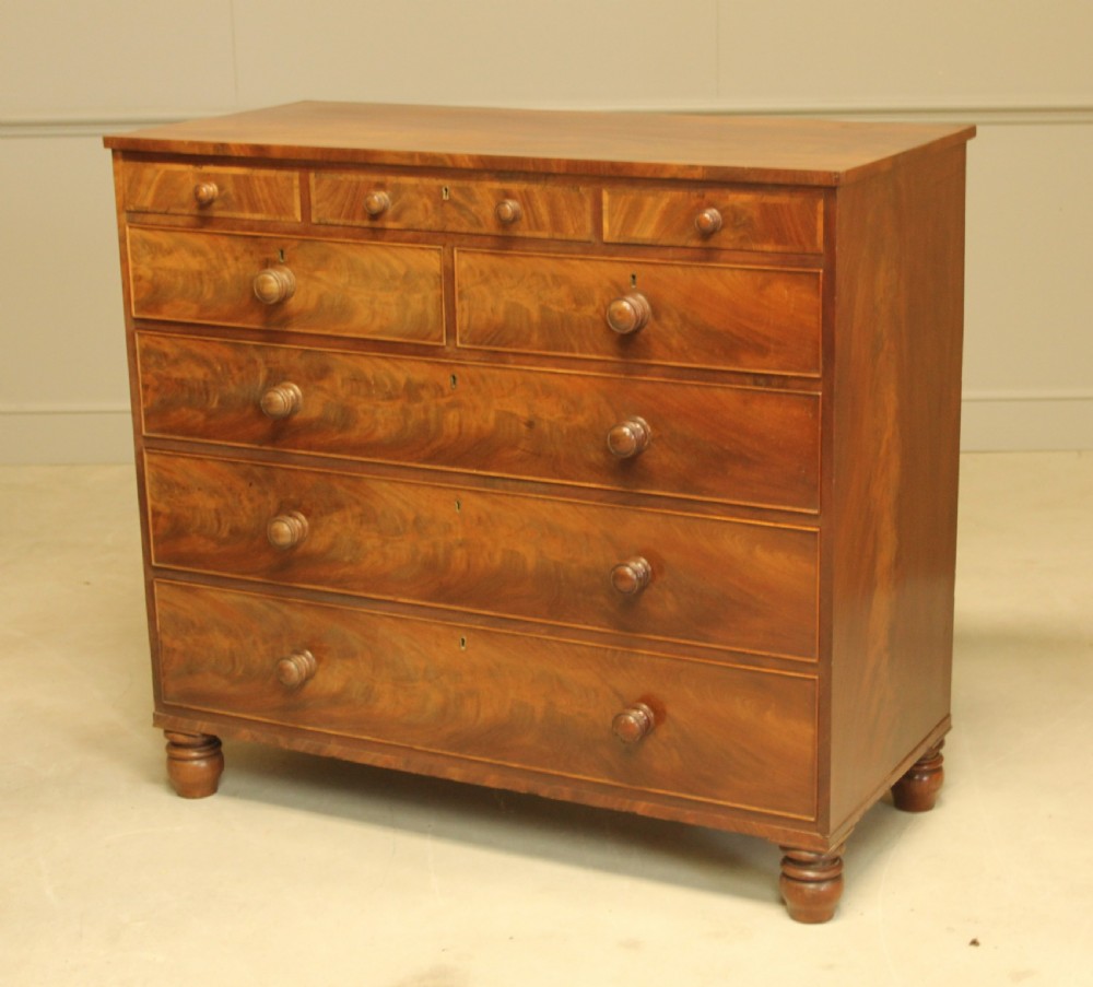 A 19th century flame mahogany chest of drawers. View VI