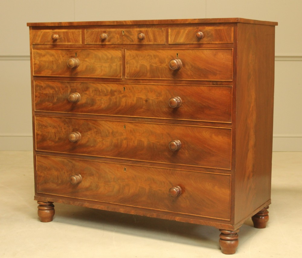 A 19th century flame mahogany chest of drawers. View VII