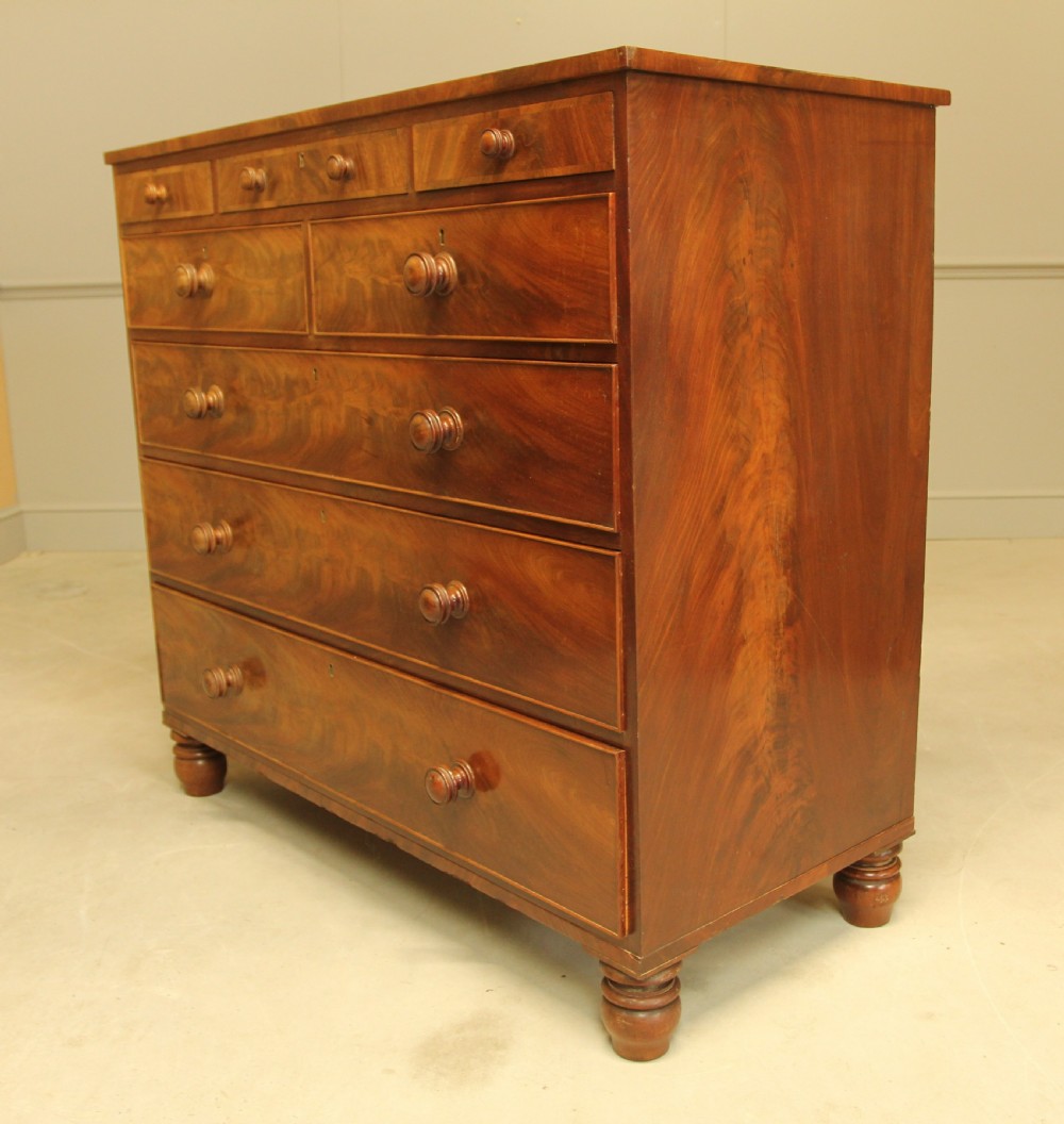 A 19th century flame mahogany chest of drawers. View VIII