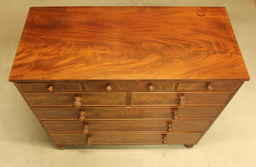 A 19th century flame mahogany chest of drawers. View IX