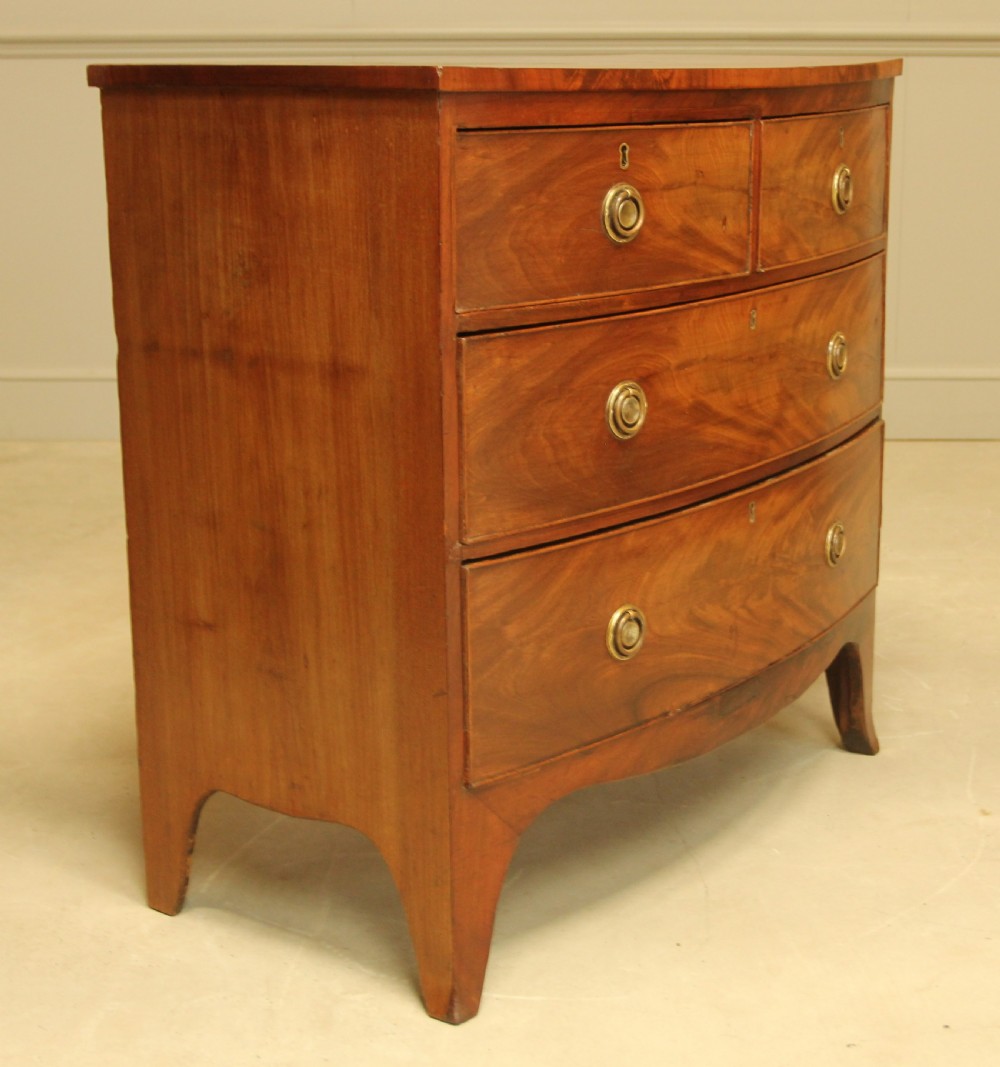 A Regency bow front chest of drawers.