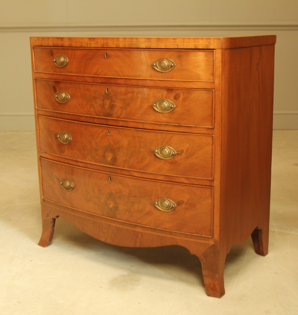 A 19TH CENTURY BOW FRONTED CHEST OF DRAWERS View III