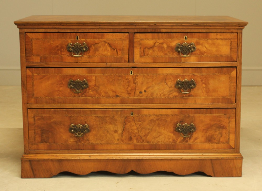A BURR WALNUT CHEST OF DRAWERS
