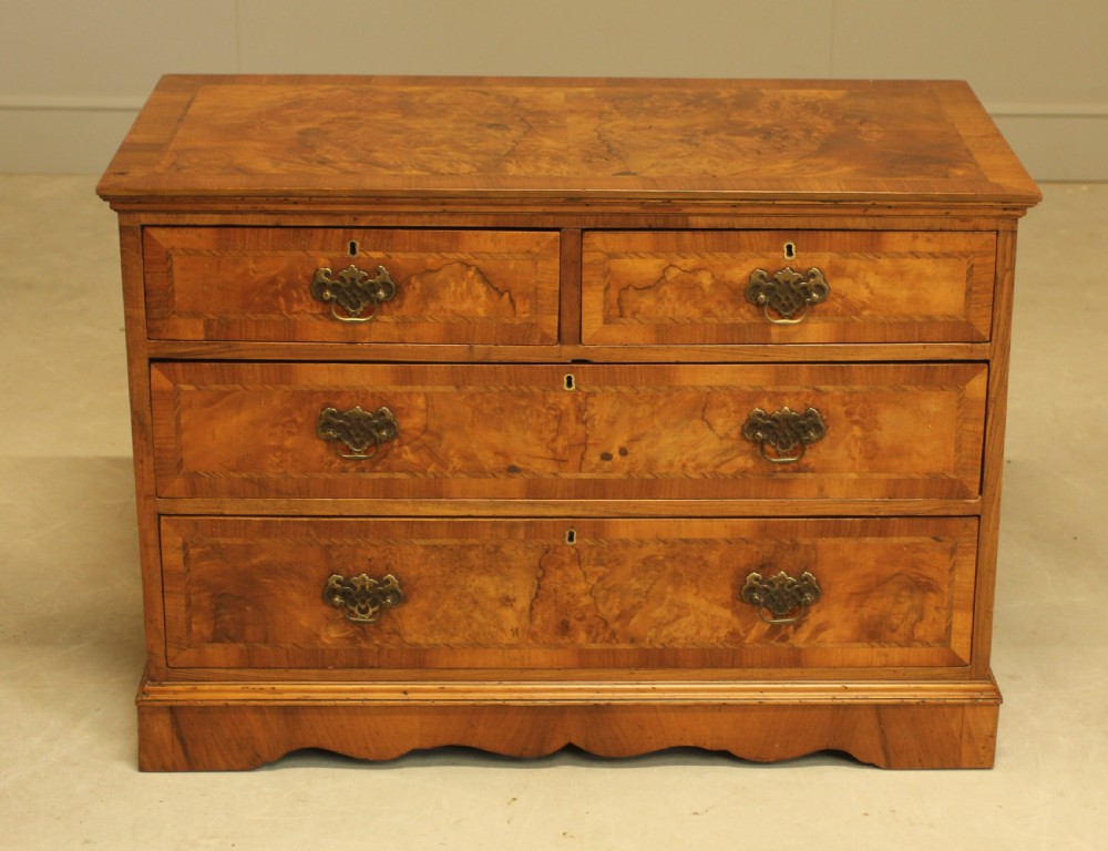 A BURR WALNUT CHEST OF DRAWERS View II