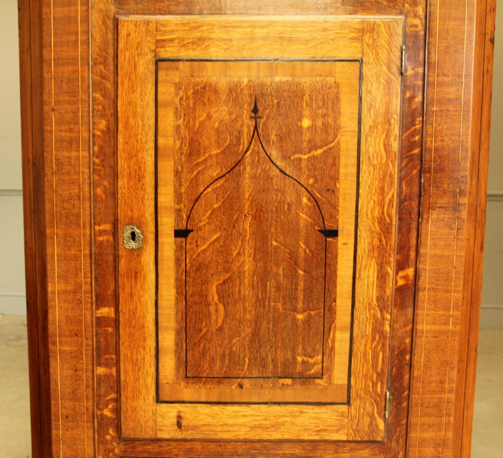 A GEORGE III OAK AND MAHOGANY CORNER CABINET. View V