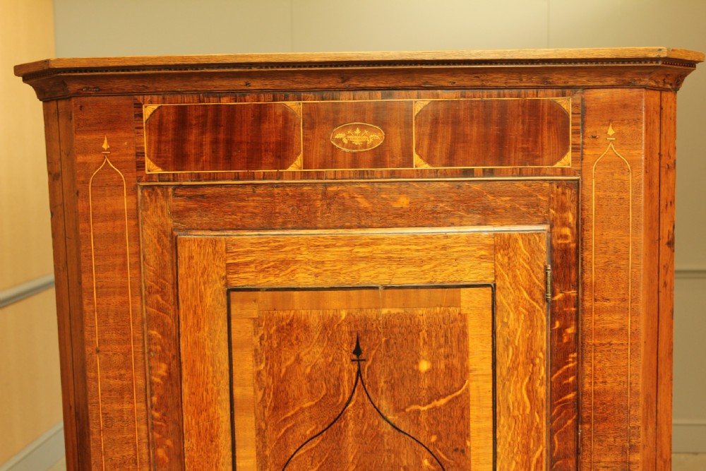 A GEORGE III OAK AND MAHOGANY CORNER CABINET. View VI