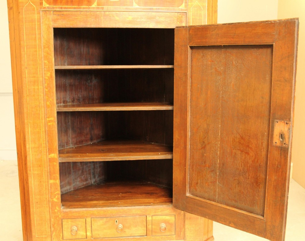 A GEORGE III OAK AND MAHOGANY CORNER CABINET. View VII