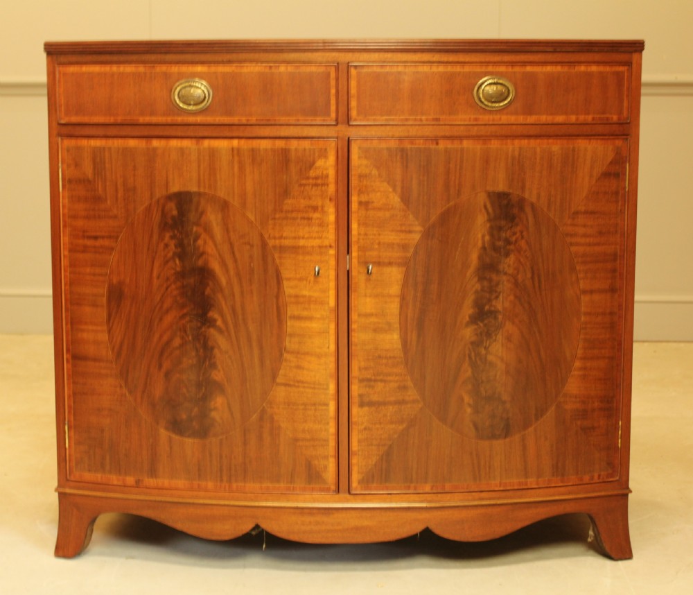 A TWO DOOR BOW FRONTED SIDEBOARD
