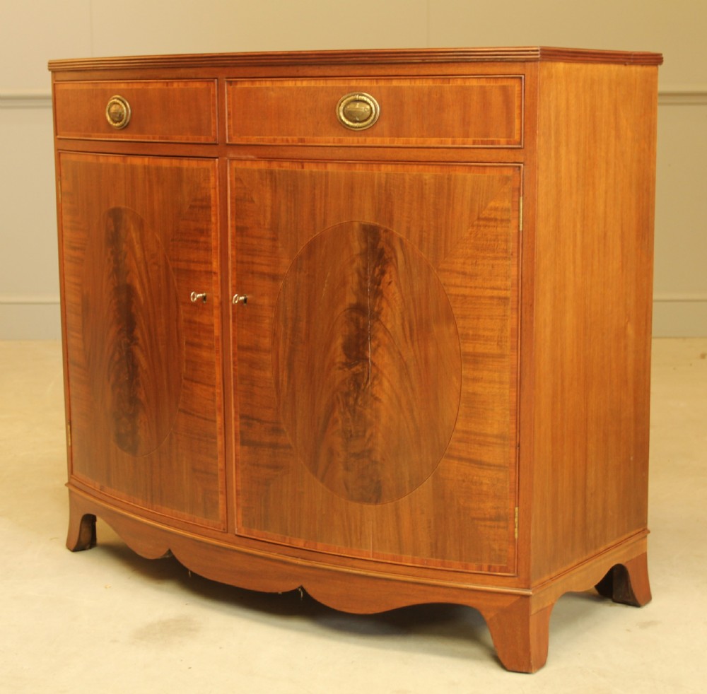 A TWO DOOR BOW FRONTED SIDEBOARD View III