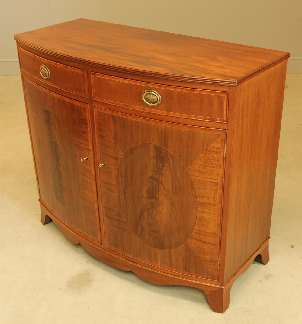 A TWO DOOR BOW FRONTED SIDEBOARD View V