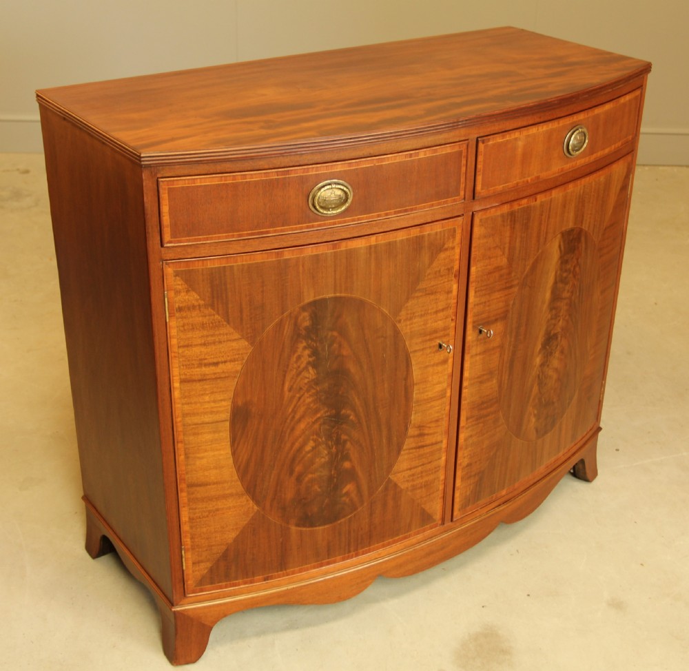 A TWO DOOR BOW FRONTED SIDEBOARD View VI