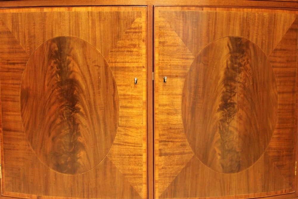 A TWO DOOR BOW FRONTED SIDEBOARD View VII
