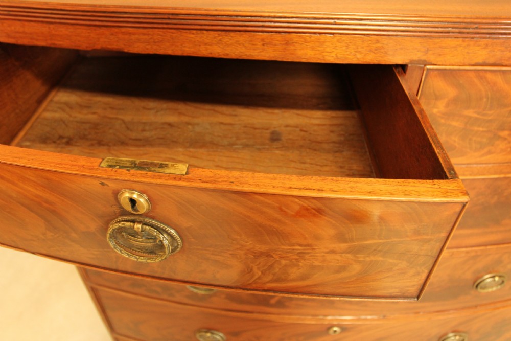 A Regency mahogany bow fronted chest of drawers. View VIII