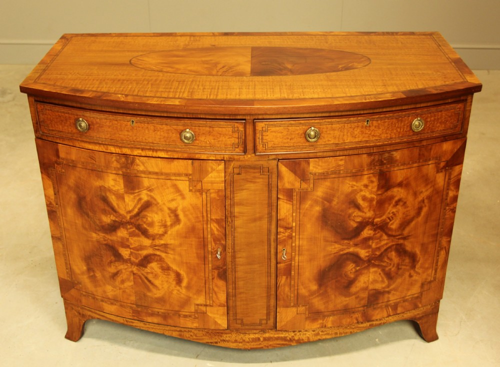 AN EDWARDIAN SATINWOOD BOW FRONTED TWO DOOR SIDEBOARD. View III