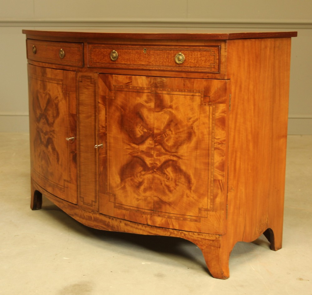 AN EDWARDIAN SATINWOOD BOW FRONTED TWO DOOR SIDEBOARD. View V