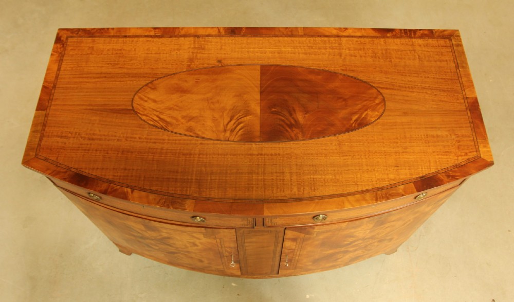 AN EDWARDIAN SATINWOOD BOW FRONTED TWO DOOR SIDEBOARD. View VIII