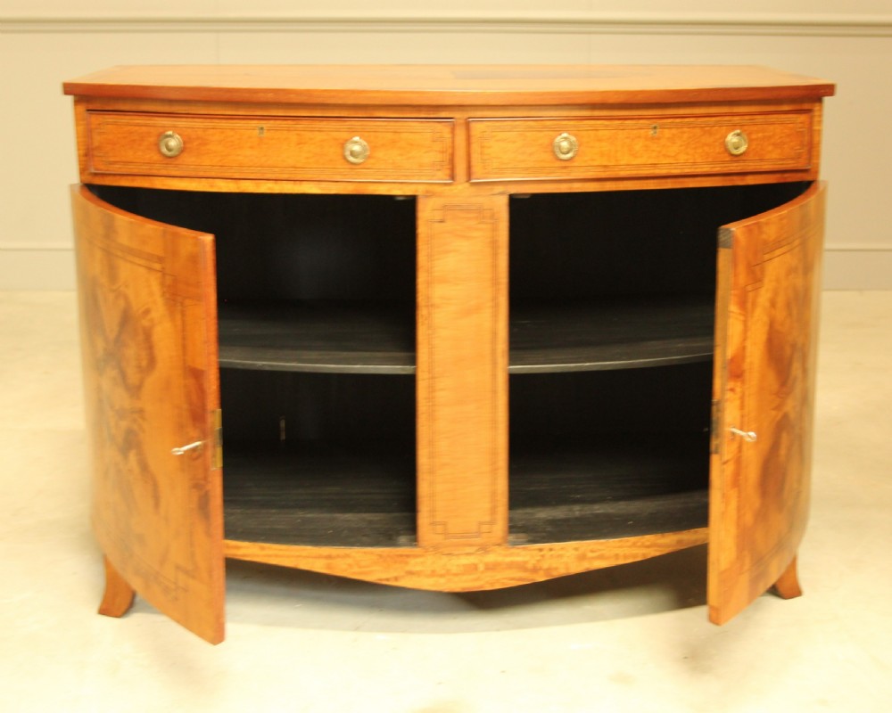 AN EDWARDIAN SATINWOOD BOW FRONTED TWO DOOR SIDEBOARD. View IX