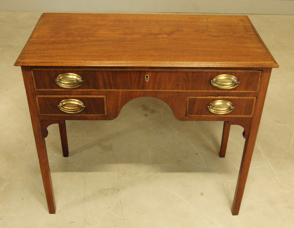 A 19th century mahogany kneehole side table.  View VIII