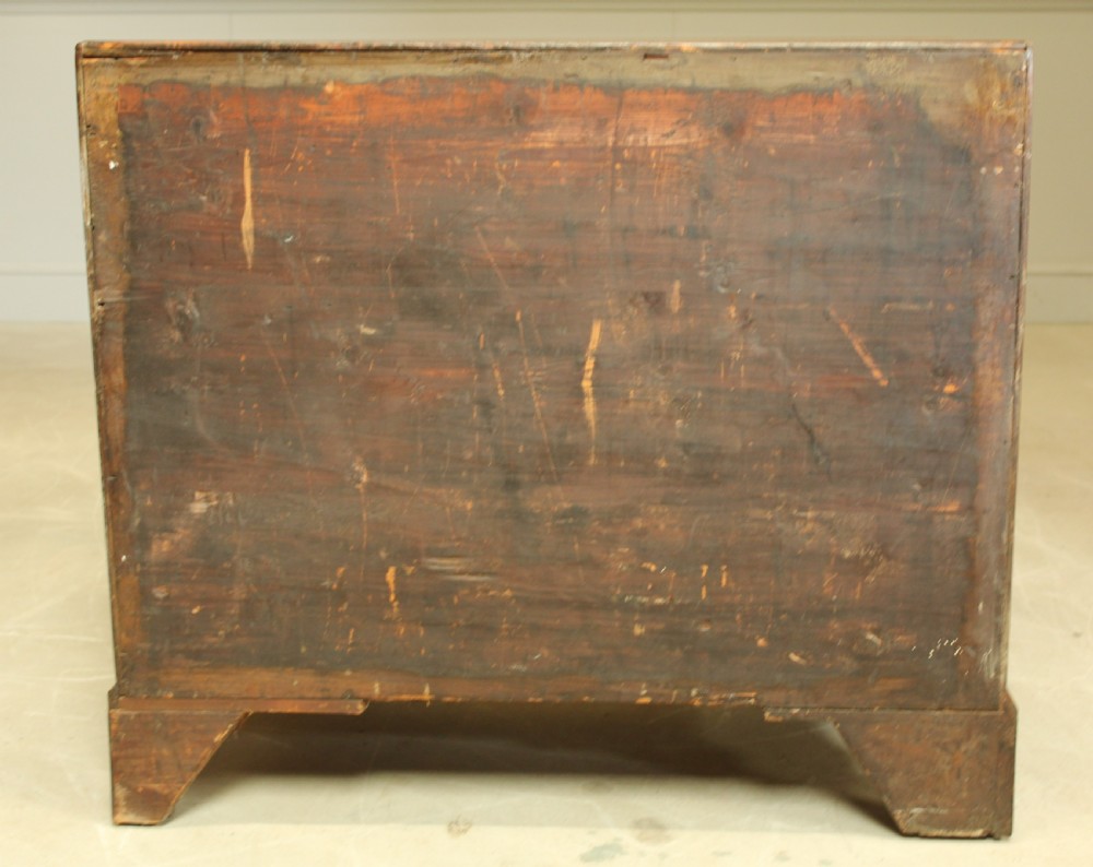 A George III mahogany kneehole desk featuring a top drawer, six side drawers, a central recessed cupboard, and decorative brass handles. View XII