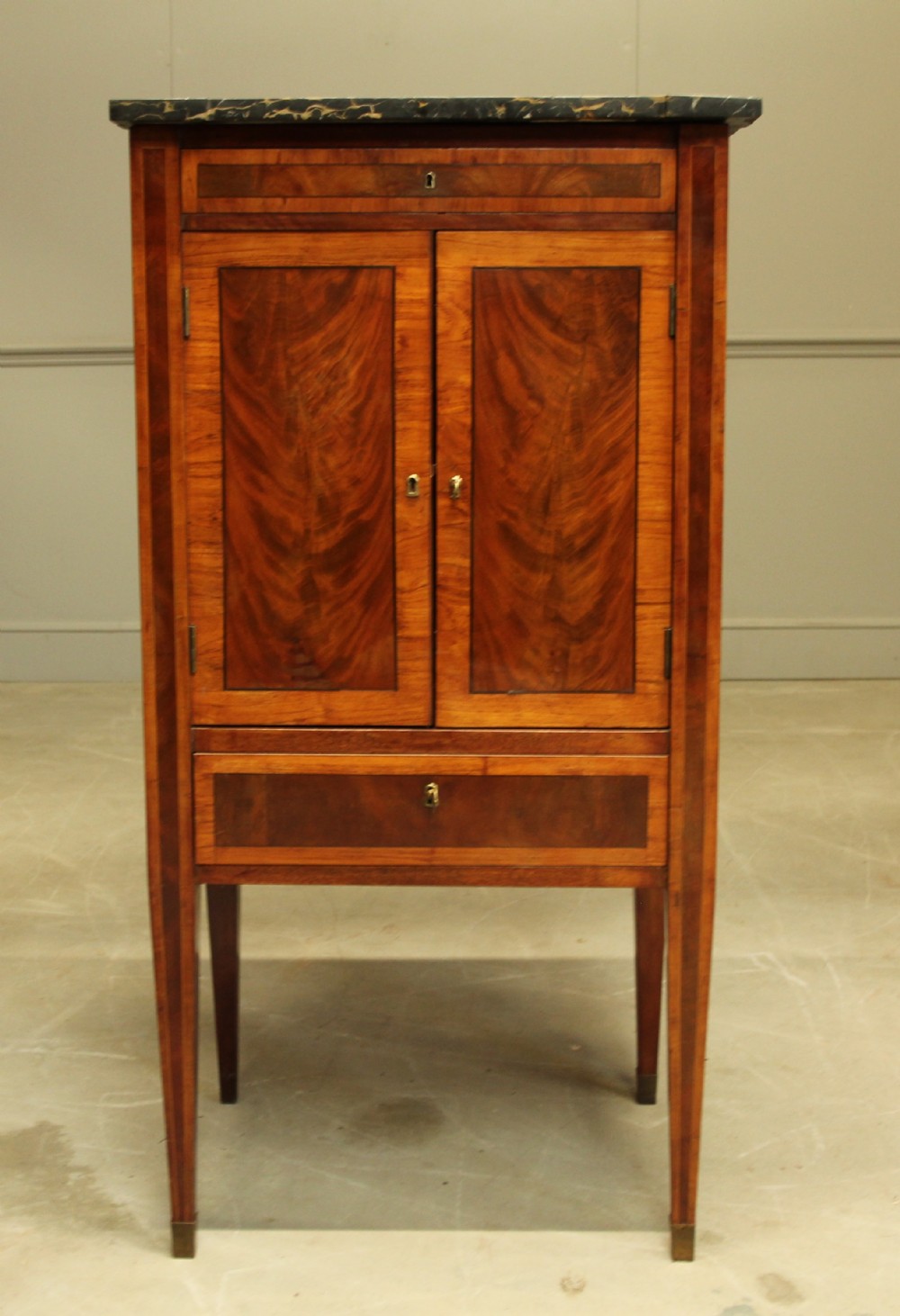 A French 19th century marble topped mahogany music cabinet.