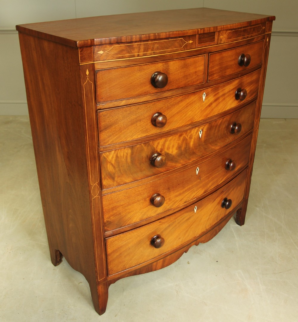 A VICTORIAN MAHOGANY BOW FRONTED CHEST OF DRAWERS. View V