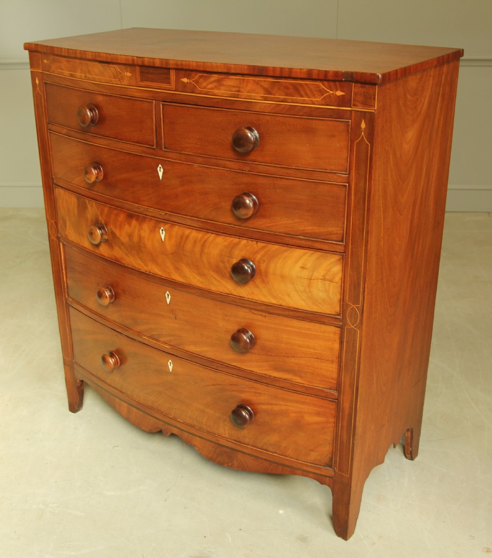A VICTORIAN MAHOGANY BOW FRONTED CHEST OF DRAWERS. View VII