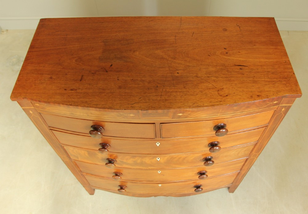A VICTORIAN MAHOGANY BOW FRONTED CHEST OF DRAWERS. View VIII