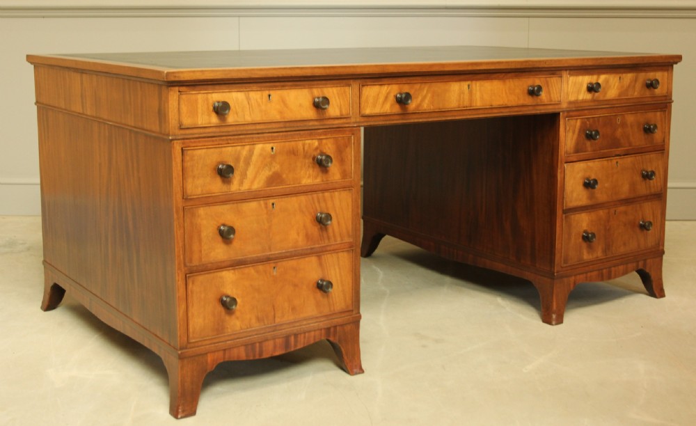 AN EARLY 20TH CENTURY CURL MAHOGANY PARTNERS DESK. View III