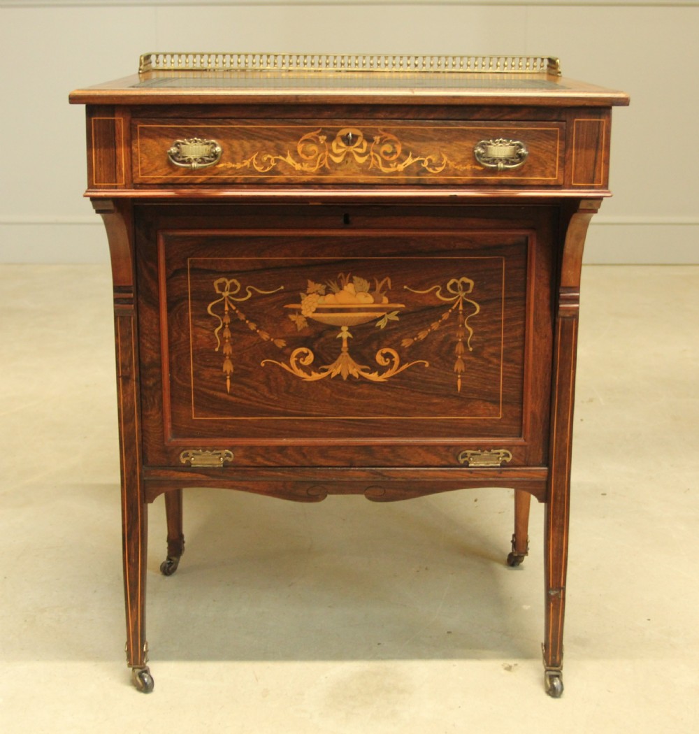 A Victorian rosewood Davenport desk featuring fine floral marquetry inlay, a black leather writing surface, a brass gallery rail, and slender tapered legs on brass castors. View III