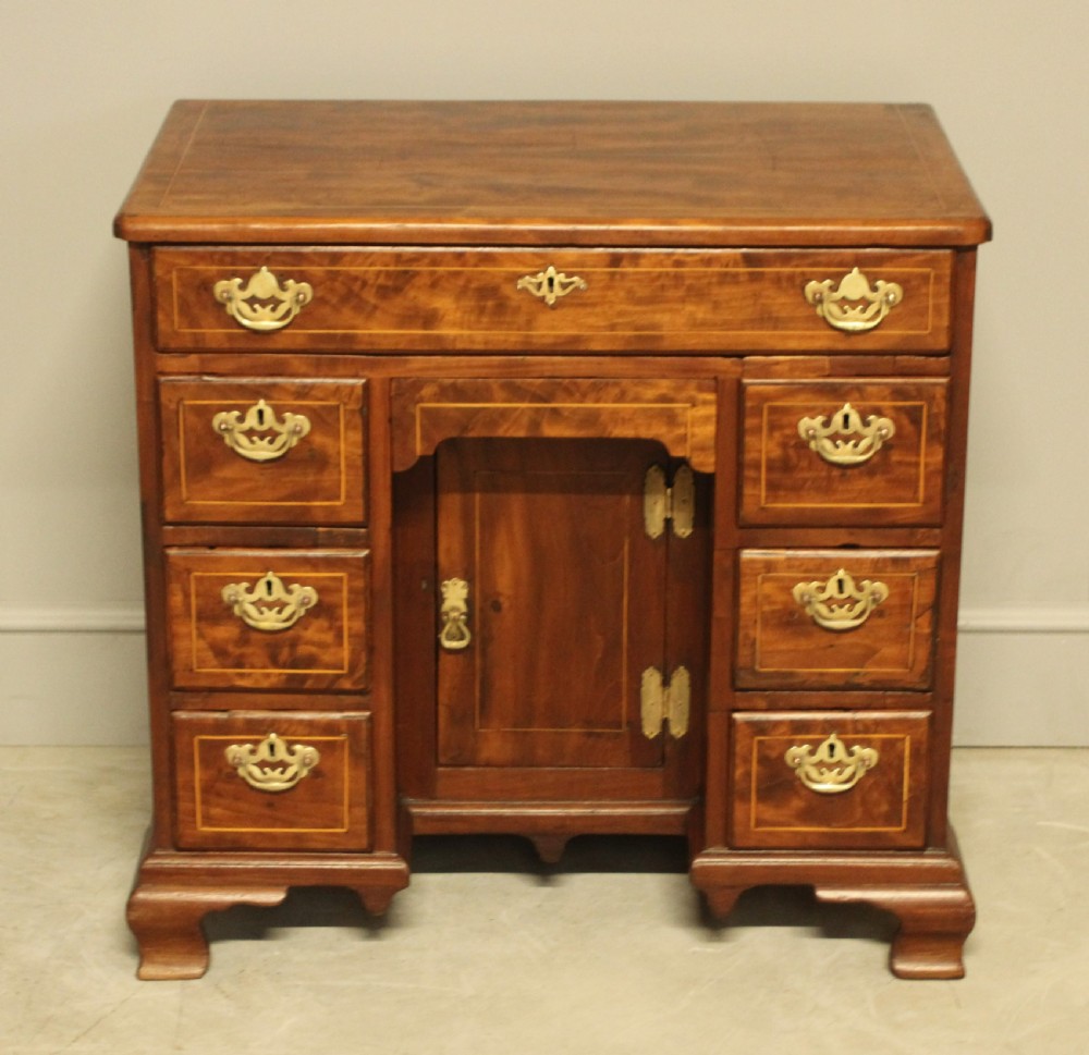 A Georgian walnut kneehole desk.  View II