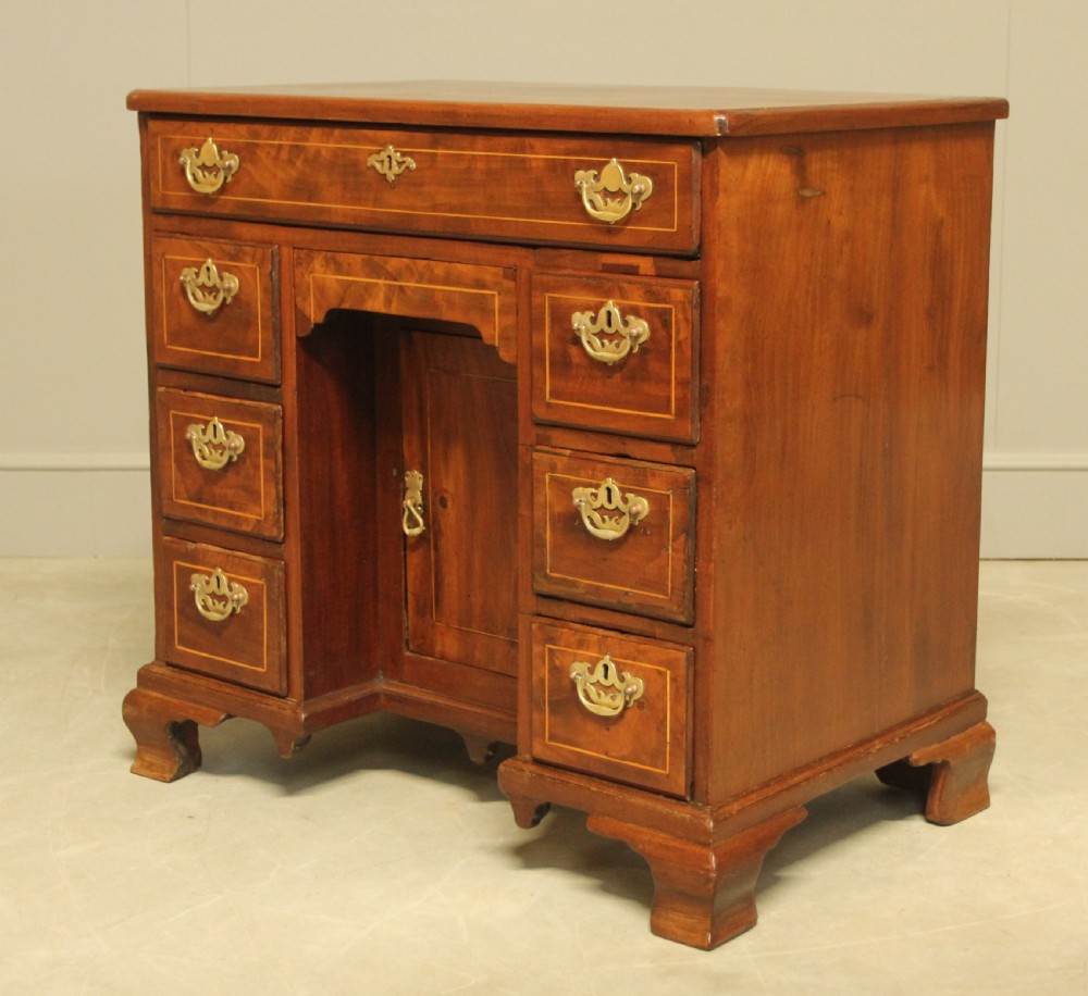 A Georgian walnut kneehole desk.  View IV