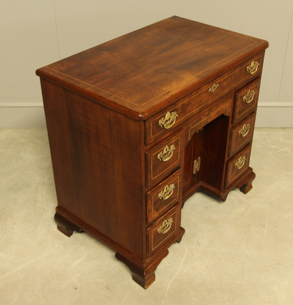 A Georgian walnut kneehole desk.  View V