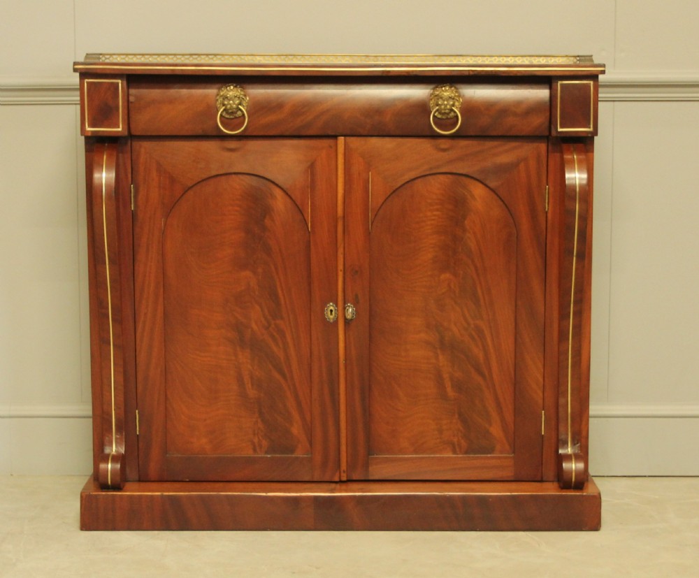 A Victorian two door brass inlaid sideboard.  