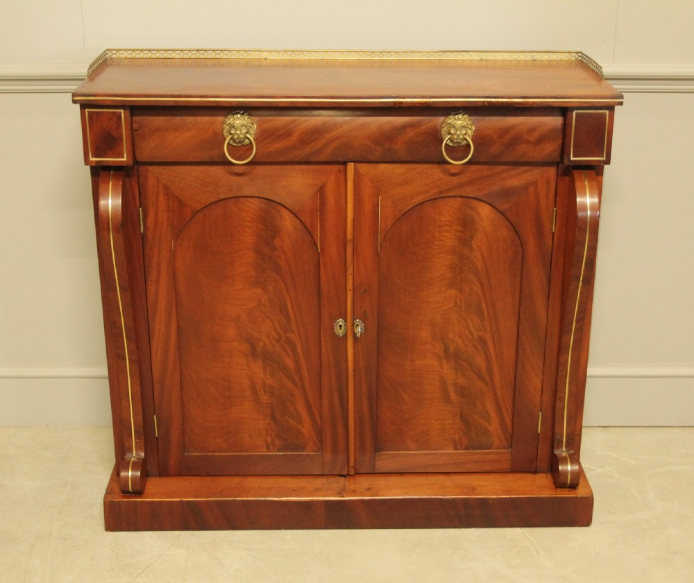 A Victorian two door brass inlaid sideboard.   View II