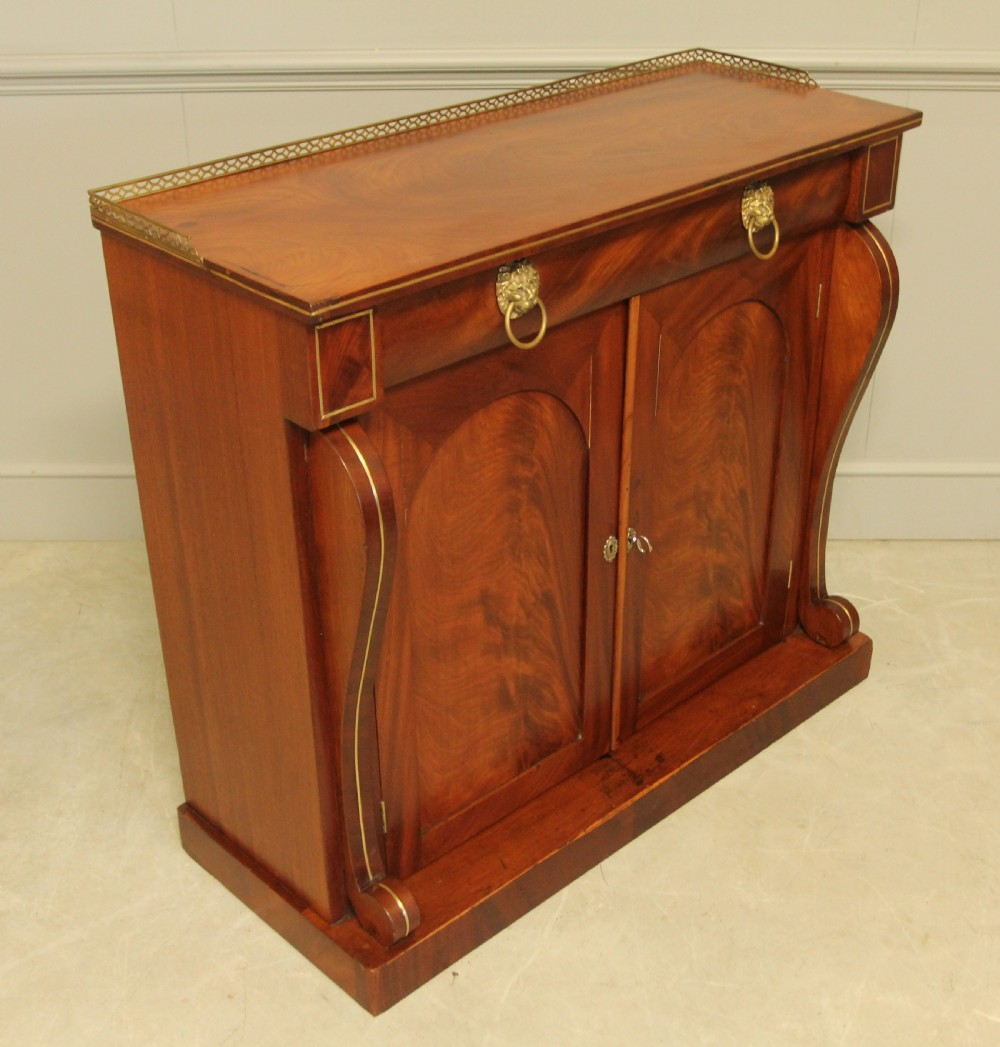 A Victorian two door brass inlaid sideboard.   View V