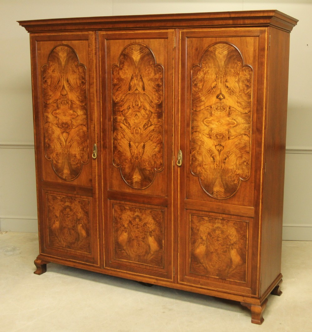 AN EARLY 20TH CENTURY BURR WALNUT TRIPLE WARDROBE.  View II