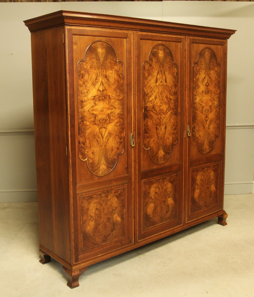 AN EARLY 20TH CENTURY BURR WALNUT TRIPLE WARDROBE.  View III