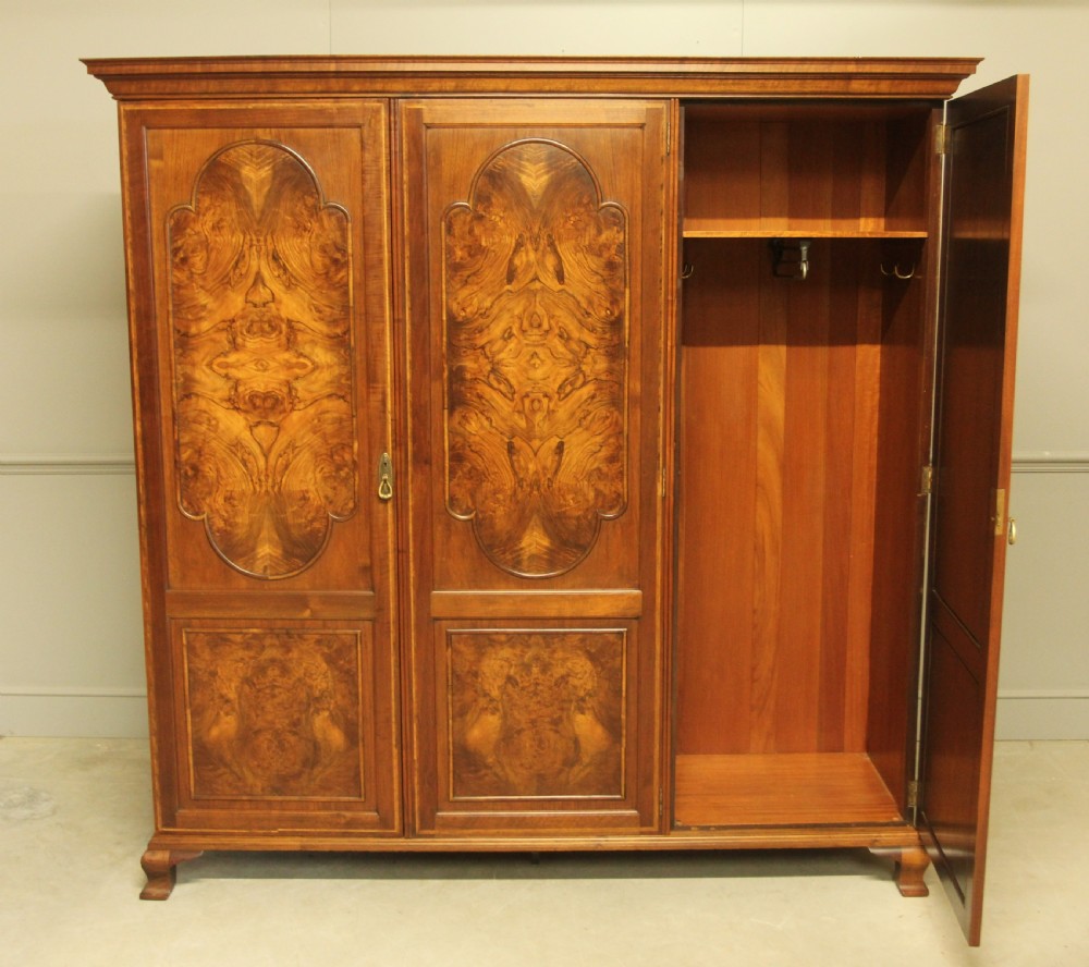 AN EARLY 20TH CENTURY BURR WALNUT TRIPLE WARDROBE.  View V