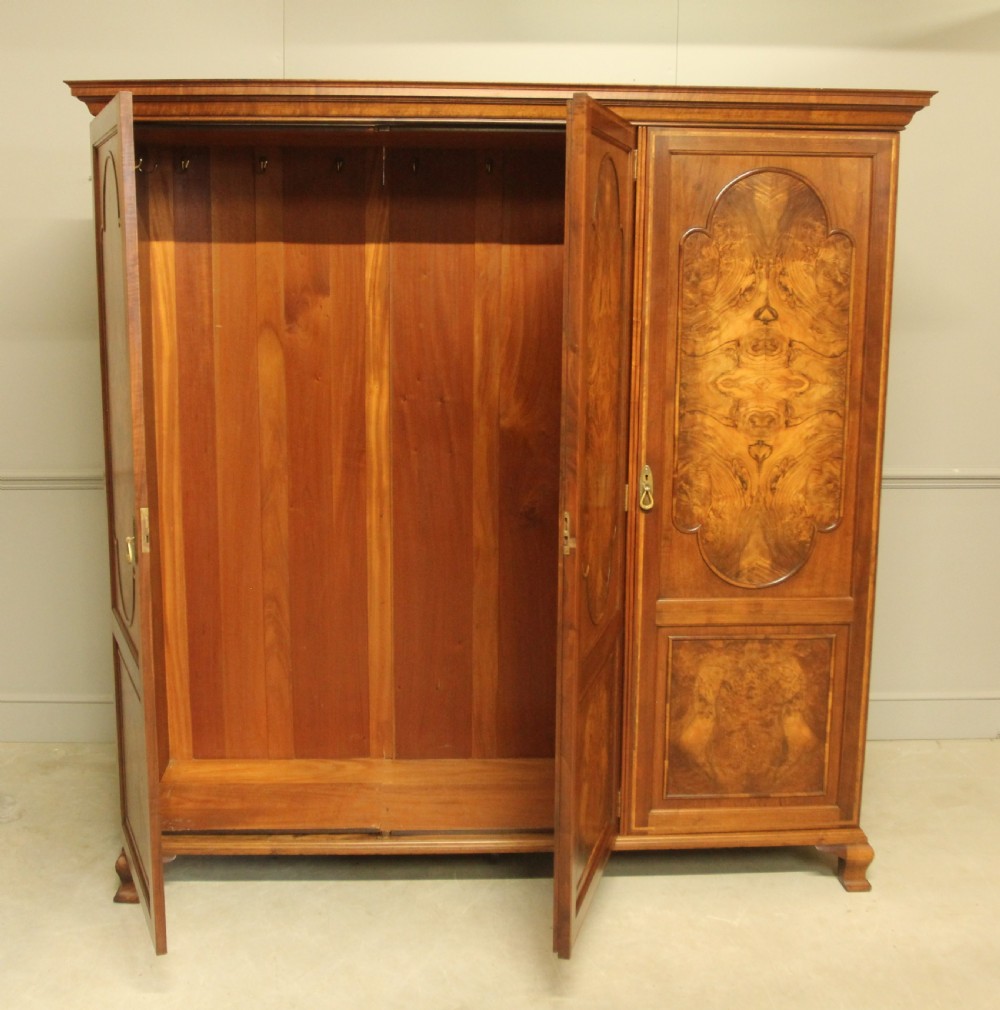 AN EARLY 20TH CENTURY BURR WALNUT TRIPLE WARDROBE.  View VII